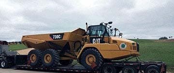 Articulated dump truck loaded for transport