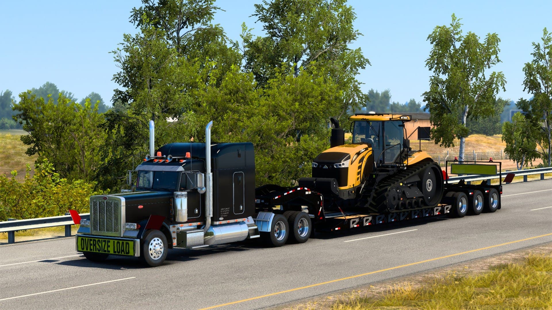A black Peterbilt heavy haul tractor pulling a Challenger tractor on a lowboy trailer beneath an OVERSIZE LOAD banner
